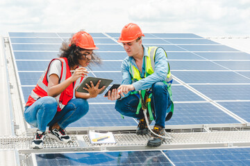 Engineer technician using laptop checking and operating system on rooftop of solar cell farm power...