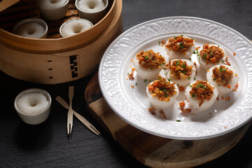 Asian food concept spot focus Chwee Kueh Strem savory rice cake on black background with copy space