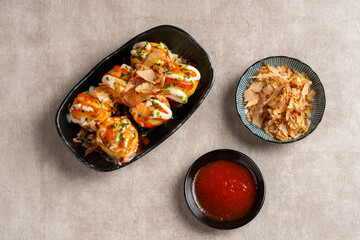 Takoyaki is a ball-shaped Japanese snack made of a wheat flour-based batter and cooked in a special molded pan