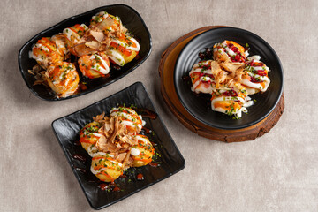 Takoyaki is a ball-shaped Japanese snack made of a wheat flour-based batter and cooked in a special molded pan