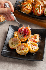 Takoyaki is a ball-shaped Japanese snack made of a wheat flour-based batter and cooked in a special molded pan