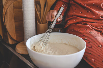 Kneading dough for pancakes, cooking homemade breakfast