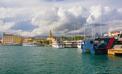 Fototapeta premium The waterfront of the historic coastal city of Split in Dalmatia, Croatia. The Cathedral of Saint Domnius bell tower is centre and the Harbour Master's Office far left