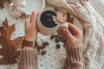 Hands with a cup of tea, good morning concept. Autumn mood