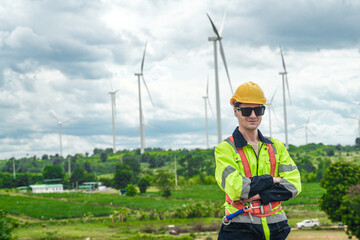 engineers man  standing at windmill turbine farm construction. Industrial Renewable energy of green...