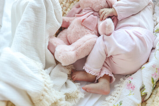 The child sleeps in an embrace with a plush toy, a happy childhood