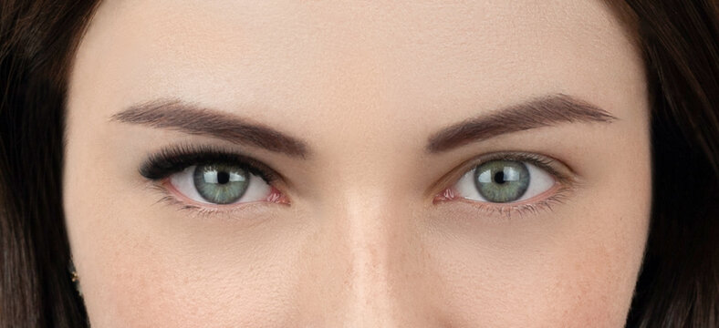 Close up shot of before and after procedure of lash extension. Macro shot of female green eyes with long false volume lashes. Young woman with perfect cat shape eye and beautiful eyelash extensions