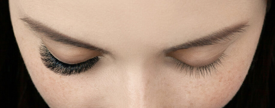 Close up shot of before and after procedure of lash extension. Macro shot of female green eyes with long false volume lashes. Young woman with perfect cat shape eye and beautiful eyelash extensions