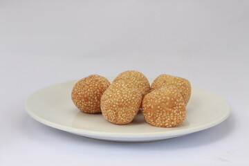 Onde-onde or jian dui is a type of cake that is popular in Indonesia. Onde-onde is a traditional food from Indonesia. Onde-onde served on a white plate