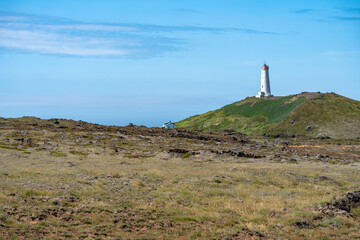 Fototapeta na wymiar Reykjanes Lighthouse in Iceland, perched on a hill, overlooking the Atlantic Ocean