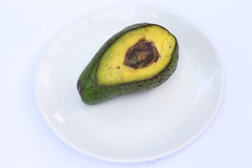 Avocado slices with seeds visible isolated on white background