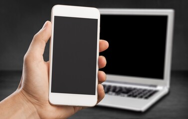 Blank screen phone on laptop background