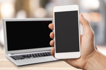 Blank screen phone on laptop background