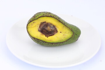 Avocado slices with seeds visible isolated on white background