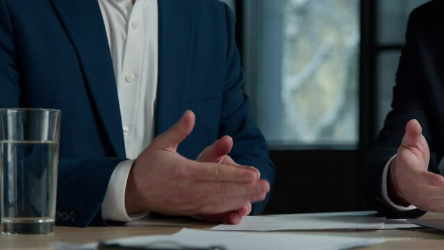 Close-up two unrecognizable businessmen men negotiating at business meeting in office advisor lawyer financial expert consulting customer explaining make deal handshake shake hands successful contract