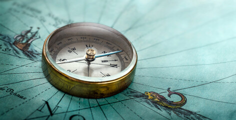 Magnetic old compass on world map. Travel, geography, history, navigation, tourism and exploration concept background. Retro compass on geography map.