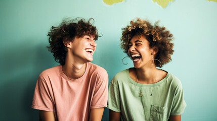 Funny best friends laughing cheerfully while standing together in a studio - obrazy, fototapety, plakaty