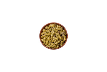 Delicious fusilli pasta with green pesto sauce, with salt and spices