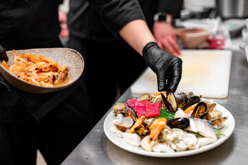 chef hand cooking Set Mixed Seafood in plate