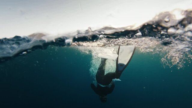 Duck dive freediving. Woman freediver does duck dive and freedives in the sea