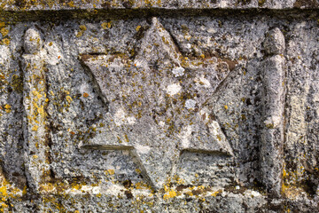 Jewish star on the tombstone. Background with selective focus