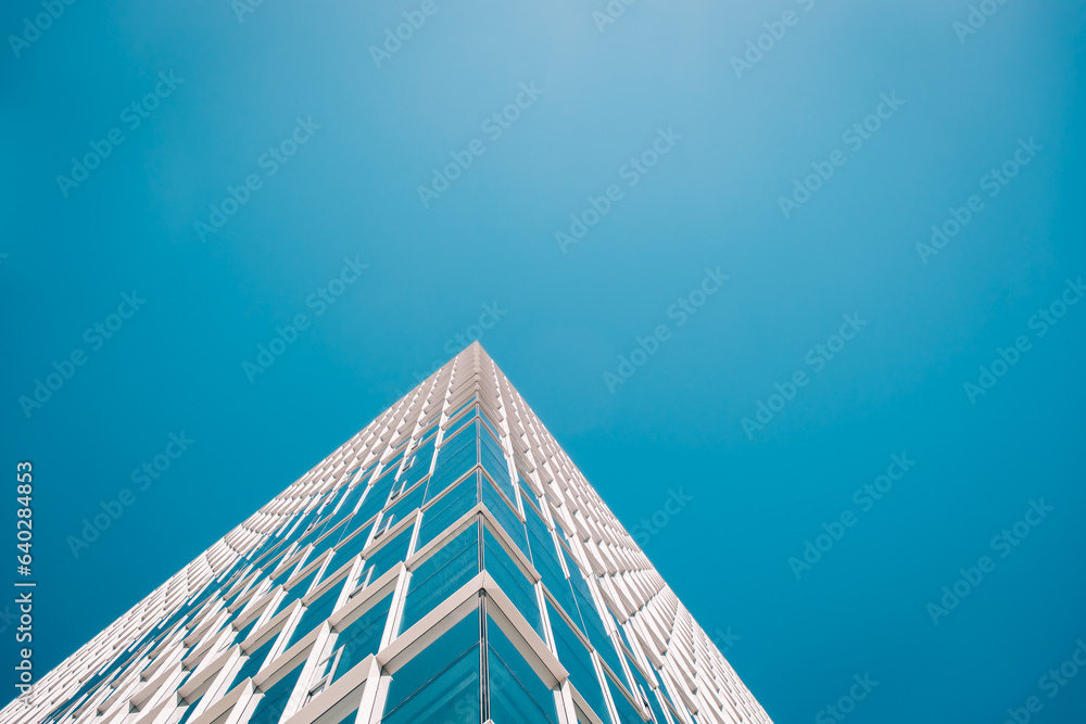 Wall mural architecture - skyscraper with plain blue sky and reflections