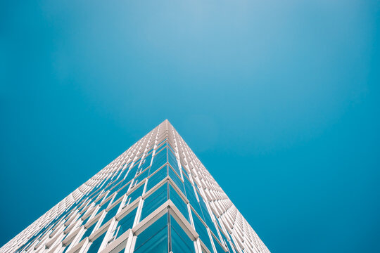 Architecture - skyscraper with plain blue sky and reflections 