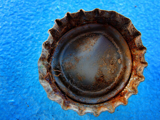 Old Rusty Bottle Cap Bottlecap on Blue Background