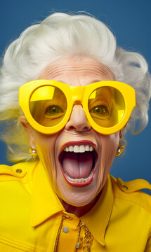A trendy older woman in a dress and big yellow sunglasses is having fun