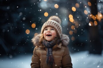 Cute child with happy face wearing a warm hat and warm jacket surrounded with snowflakes. Winter holidays concept. - obrazy, fototapety, plakaty