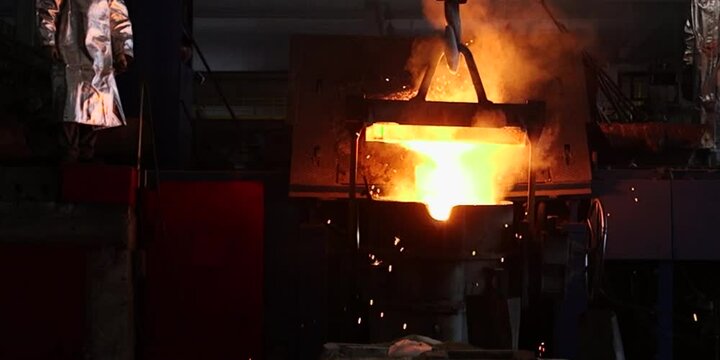 Liquid iron molten metal pouring in container, industrial metallurgical factory, foundry cast, heavy industry