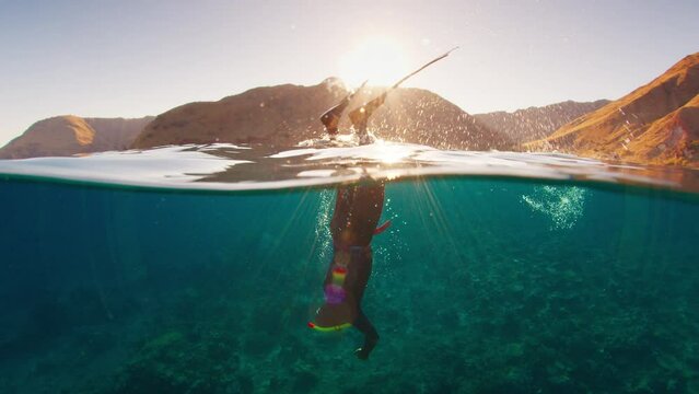 Duck dive freediving. Male freediver does duck dive and freedives in the sea