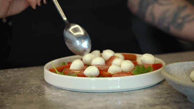 Mozzarella cheese balls and red cherry tomato, Turning. selective focus. canapes with mini mozzarella, tomatoes cherry and basil with soy sauce