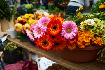 Yellow, red and pink flowers at a market stall