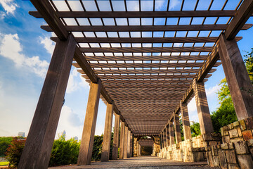 A view of a park from a wooden pergola at midtown park in Charlotte, North Carolina, USA.