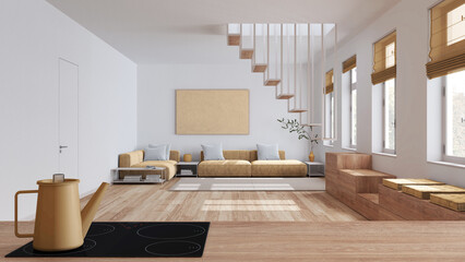 Wooden kitchen work top with induction hob and teapot close up. Nordic living room in white and yellow tones. Sofa and minimal staircase. Scandinavian interior design