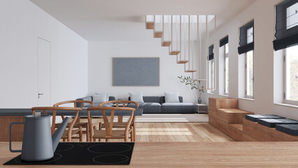 Obraz premium Wooden kitchen work top with induction hob and teapot close up. Nordic living and dining room in white and gray tones. Sofa and staircase. Minimal interior design