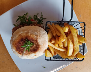 Full beef burger with chips in a country restaurant