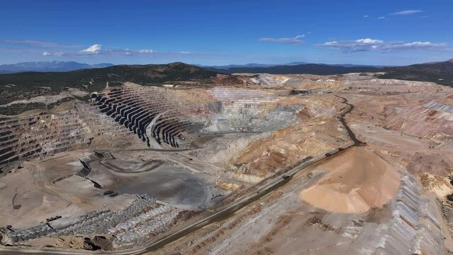 Aerial copper gold open pit mine Ely Nevada 4K fast. Copper and gold discovered in Ely Nevada in late 1800's. Boom town along historic Pony Express trail. Ore transported to Japan for smelting.