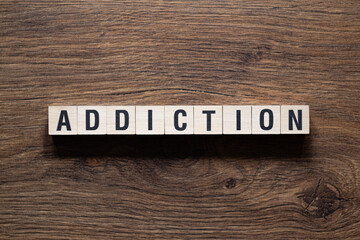 Addiction - word concept on building blocks, text