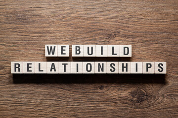 We build relationships - word concept on building blocks, text