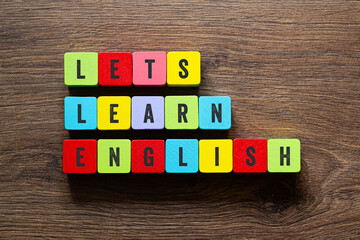 Let's learn english - word concept on building blocks, text
