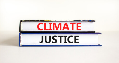 Climate justice symbol. Concept words Climate justice on beautiful books. Beautiful white table white background. Business environment climate justice concept. Copy space.