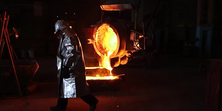 Liquid iron molten metal pouring in container, industrial metallurgical factory, foundry cast, heavy industry 