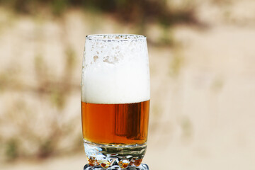 Beer with foam in a glass with a beautiful background.