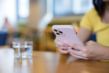 Woman use of mobile phone at coffee shop