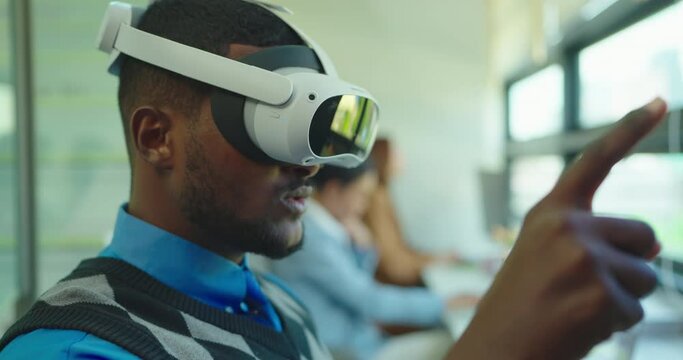 Businessman wearing VR and using to work. He utalking with ream while wearing VR goggles.