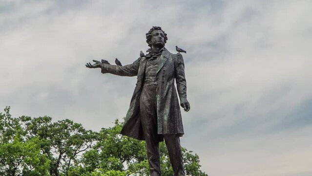 Alexander Pushkin Monument on Arts Square, Russian Museum (Mikhailovsky Palace) backdrop, captured in timelapse hyperlapse. St. Petersburg, Russia. Close up view