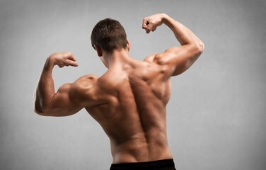 Fototapeta premium Portrait of bodybuilder sporty young man in studio,