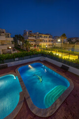illuminated swimming pool at night